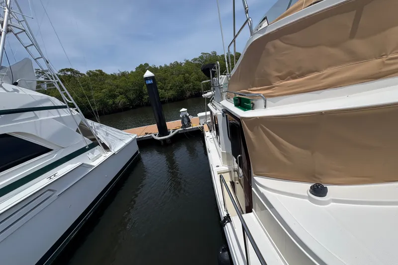 Slide: The Image of 2020 Ranger Tugs R-31 CB docked beside another boat in a serene marina. - 35