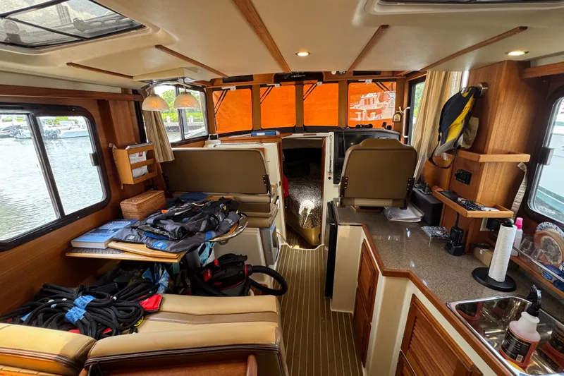 Slide: The Image of Interior of 2020 Ranger Tugs R-31 CB boat with cozy seating and nautical equipment. - 15