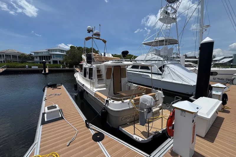 Slide: The Image of 2020 Ranger Tugs R-31 CB docked at marina under clear sky. - 3
