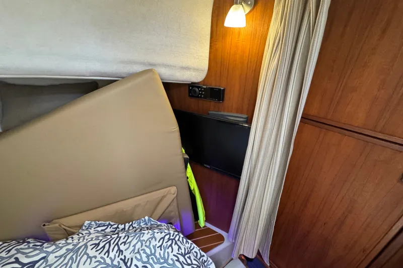 Slide: The Image of Cozy interior of 2020 Ranger Tugs R-31 CB with wood paneling and soft lighting. - 31
