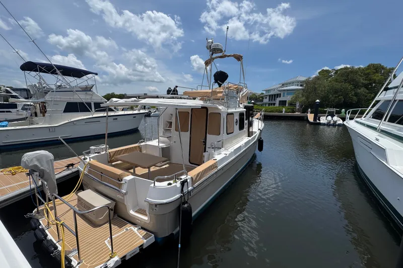 Slide: The Image of 2020 Ranger Tugs R-31 CB docked at marina under clear blue sky. - 4