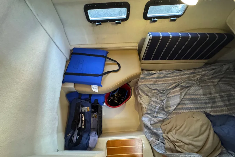 Slide: The Image of 2020 Ranger Tugs R-31 CB cabin interior with storage bags and bedding. - 18