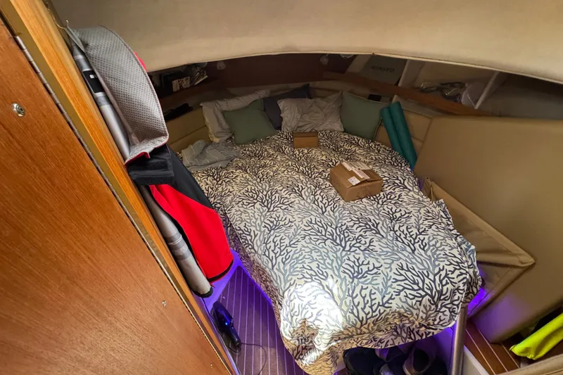 Slide: The Image of Cozy cabin interior of 2020 Ranger Tugs R-31 CB with patterned bedding and ambient lighting. - 27