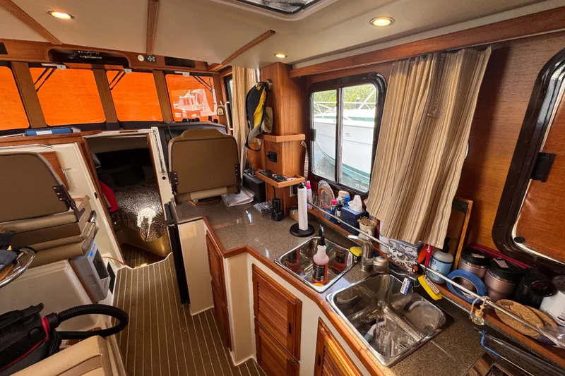 Slide: The Image of Interior of 2020 Ranger Tugs R-31 CB boat with kitchen and seating area. - 21