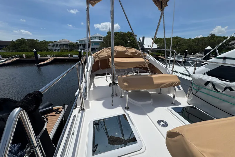 Slide: The Image of 2020 Ranger Tugs R-31 CB boat docked, featuring spacious deck and seating area. - 12