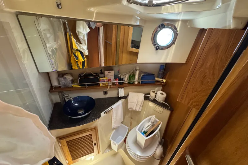 Slide: The Image of Compact bathroom in 2020 Ranger Tugs R-31 CB boat with modern amenities and porthole window. - 25