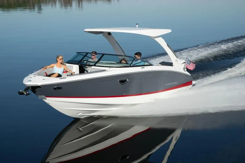 Slide: The Image of Manufacturer Provided Image: 2026 Regal LX6 boat cruising on calm water with passengers enjoying the ride. - 8