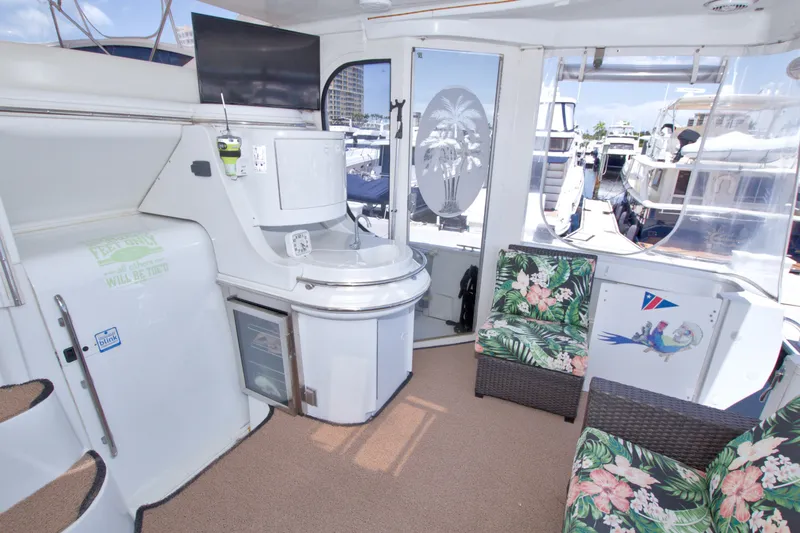 Slide: The Image of Interior of 2001 Carver 466 Motor Yacht with tropical-themed seating and modern amenities. - 7