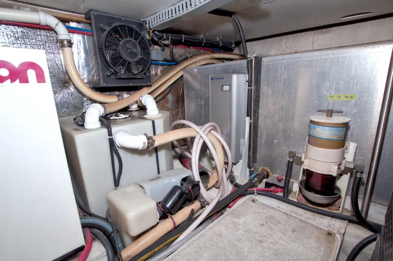 Slide: The Image of Engine room of 2001 Carver 466 Motor Yacht with various mechanical components. - 68