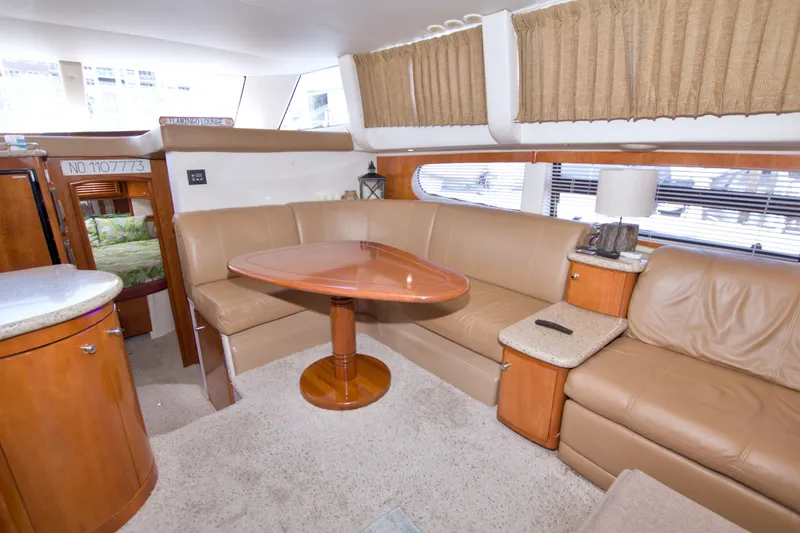 Slide: The Image of Interior of 2001 Carver 466 Motor Yacht with leather seating and wooden table. - 33