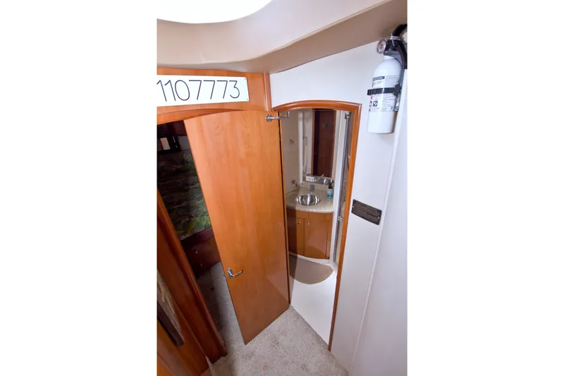 Slide: The Image of Interior view of 2001 Carver 466 Motor Yacht bathroom with wooden door and sink. - 49