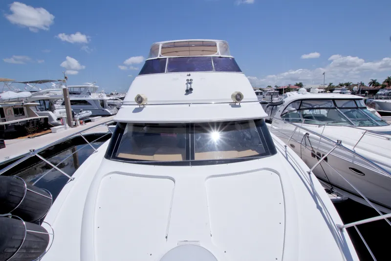 Slide: The Image of 2001 Carver 466 Motor Yacht docked at marina under clear blue sky. - 14