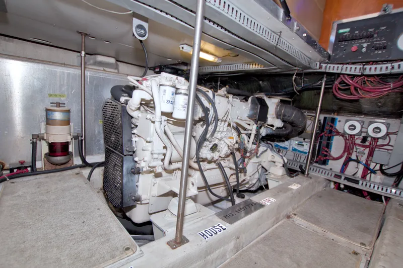 Slide: The Image of Engine room of a 2001 Carver 466 Motor Yacht, showcasing mechanical components and wiring. - 70