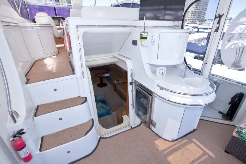 Slide: The Image of 2001 Carver 466 Motor Yacht interior with stairs, sink, and seating area. - 31