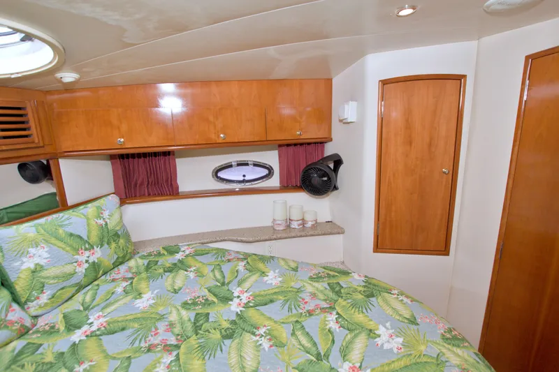 Slide: The Image of Cozy bedroom in 2001 Carver 466 Motor Yacht with tropical bedding and wooden cabinetry. - 44