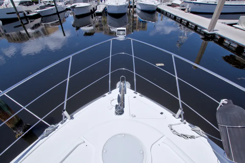 Slide: The Image of Bow view of 2001 Carver 466 Motor Yacht docked at marina. - 12