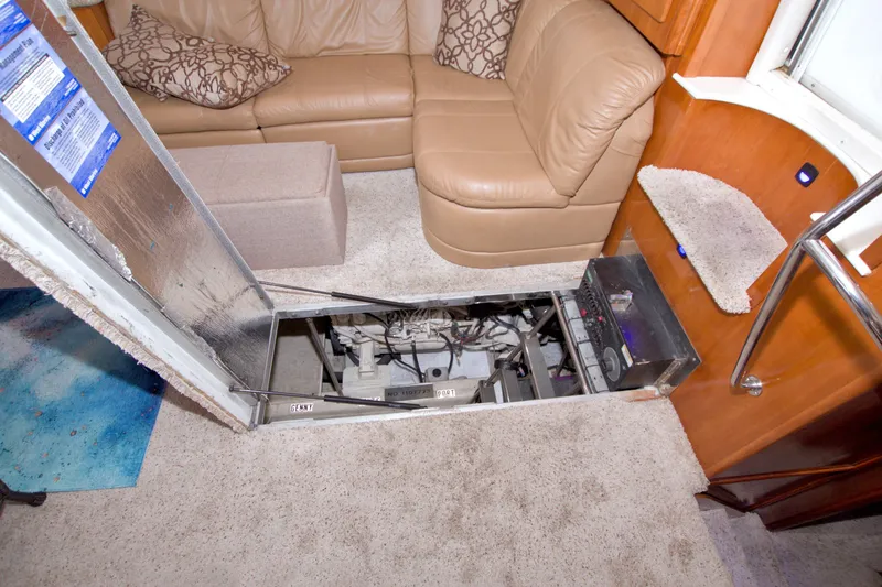 Slide: The Image of Interior of 2001 Carver 466 Motor Yacht showing engine access under carpeted floor. - 65
