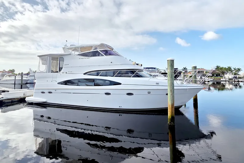 The Image of 2001 Carver 466 Motor Yacht docked in a serene marina setting. - 0