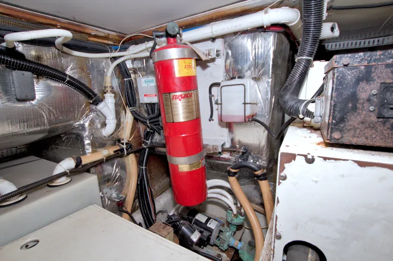 Slide: The Image of Engine room of 2001 Carver 466 Motor Yacht with fire extinguisher and wiring. - 84