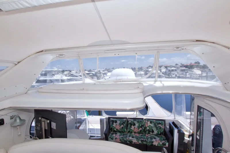 Slide: The Image of Interior view of a 2001 Carver 466 Motor Yacht with marina background. - 29