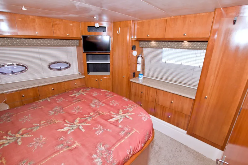 Slide: The Image of Luxurious 2001 Carver 466 Motor Yacht bedroom with wood cabinetry and elegant decor. - 61