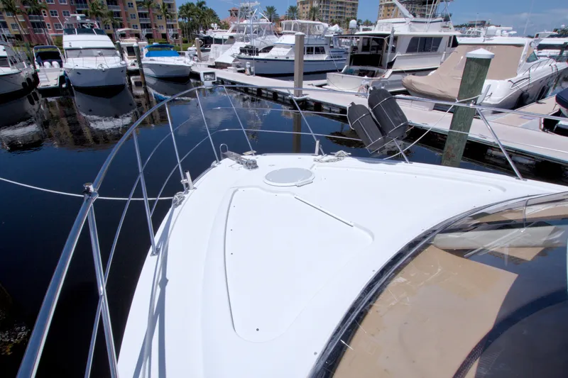 Slide: The Image of 2001 Carver 466 Motor Yacht docked in a marina with other boats. - 11