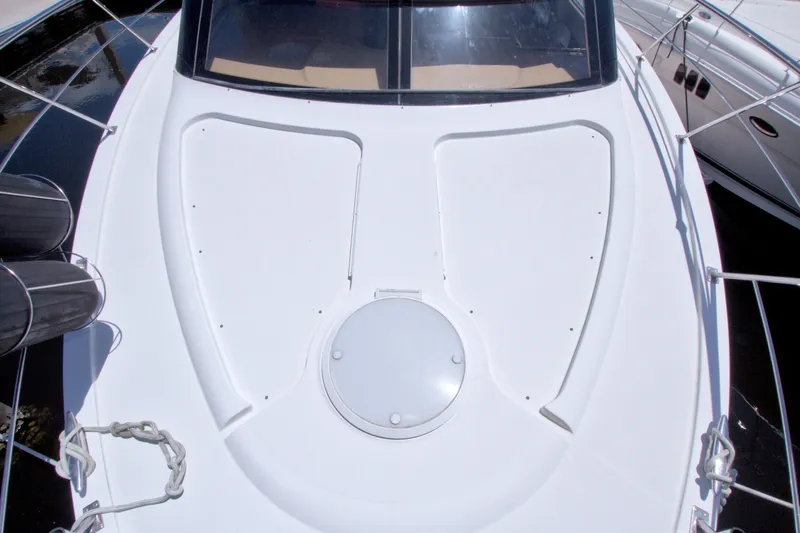 Slide: The Image of 2001 Carver 466 Motor Yacht deck with hatch and railing, docked beside another boat. - 13