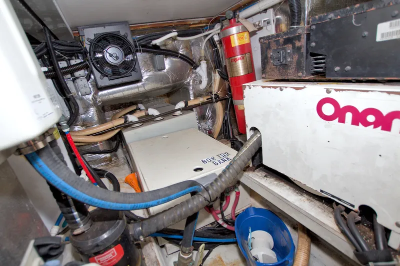 Slide: The Image of Engine room of 2001 Carver 466 Motor Yacht with Onan generator and fire extinguisher. - 83