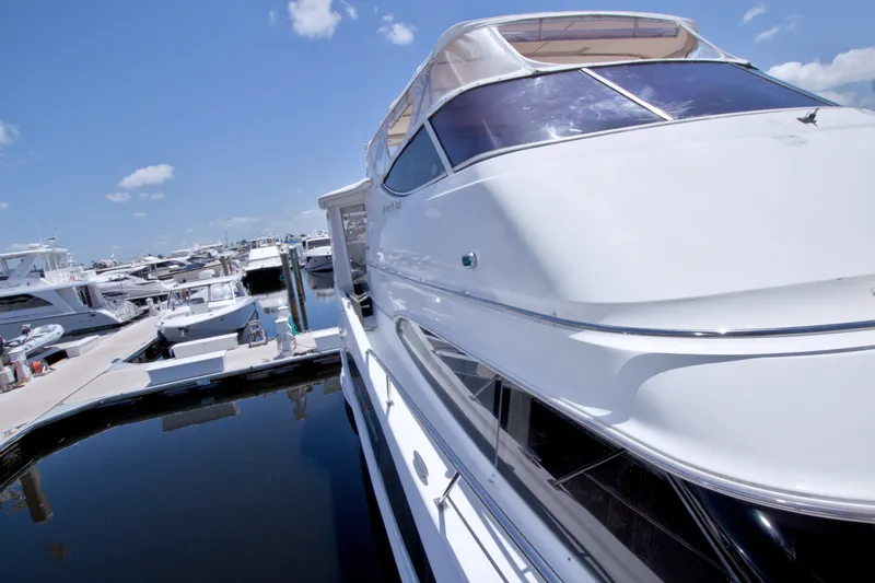 Slide: The Image of 2001 Carver 466 Motor Yacht docked at a marina under a clear blue sky. - 15