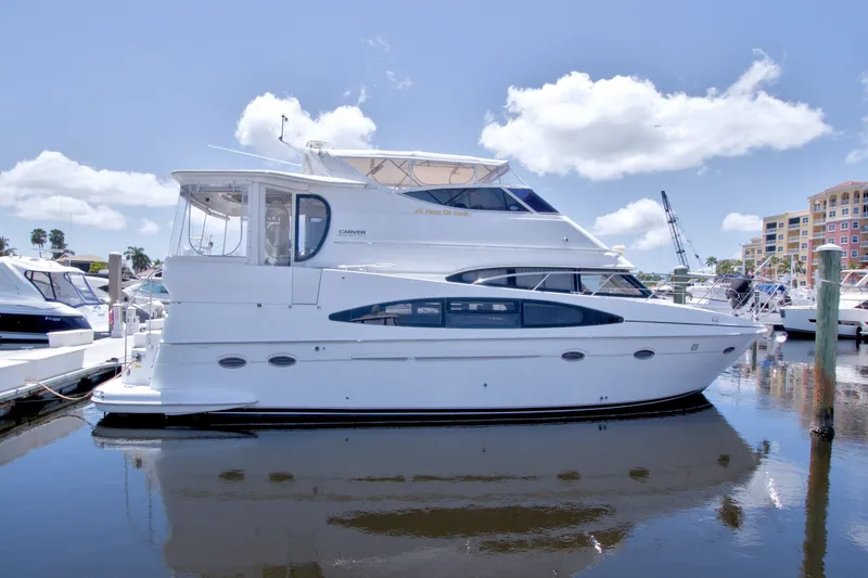 Slide: The Image of 2001 Carver 466 Motor Yacht docked at marina under clear blue sky. - 1