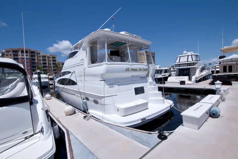 Slide: The Image of 2001 Carver 466 Motor Yacht docked at marina under clear blue sky. - 2