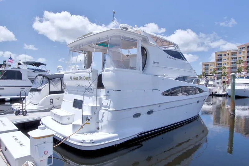 Slide: The Image of 2001 Carver 466 Motor Yacht docked at marina under blue sky. - 4