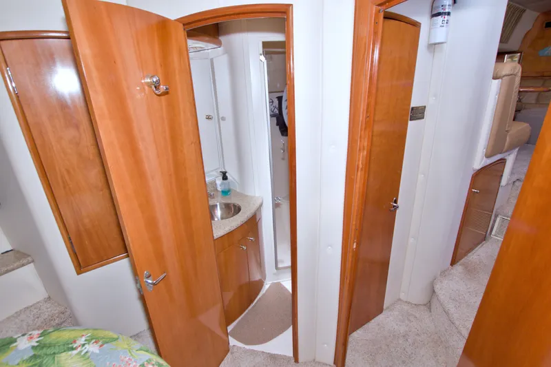Slide: The Image of Interior of 2001 Carver 466 Motor Yacht with wooden cabinetry and compact bathroom. - 46