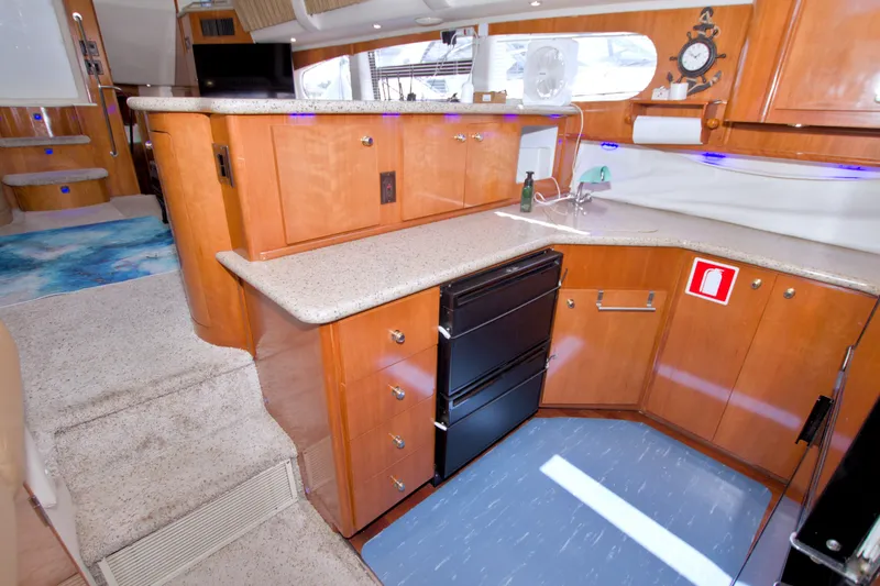 Slide: The Image of Interior of 2001 Carver 466 Motor Yacht with modern kitchen and wooden cabinetry. - 38