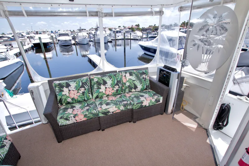 Slide: The Image of 2001 Carver 466 Motor Yacht interior with floral seating, docked at marina. - 6