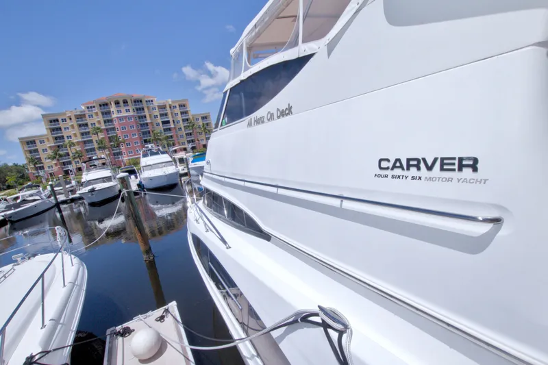 Slide: The Image of 2001 Carver 466 Motor Yacht docked at marina with waterfront buildings. - 10