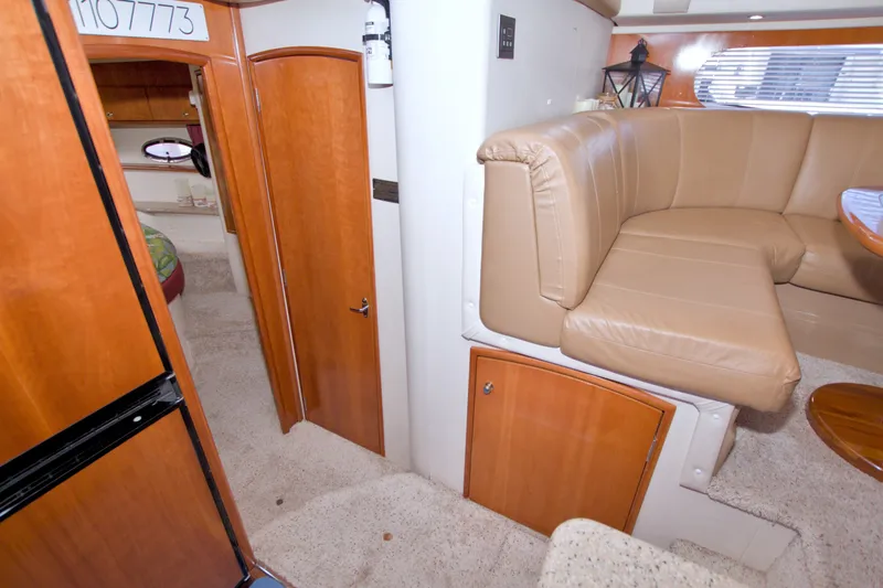 Slide: The Image of Interior of 2001 Carver 466 Motor Yacht with beige seating and wooden cabinetry. - 50