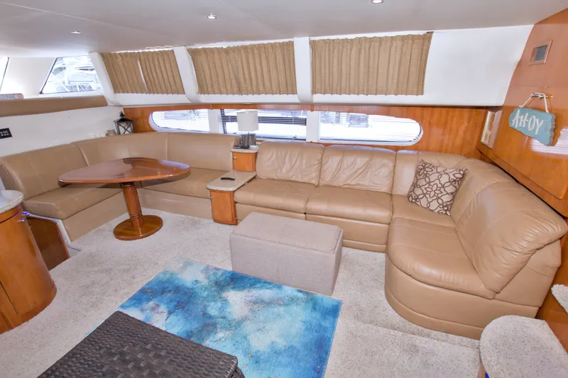 Slide: The Image of Luxurious interior of 2001 Carver 466 Motor Yacht with beige leather seating and wooden accents. - 34