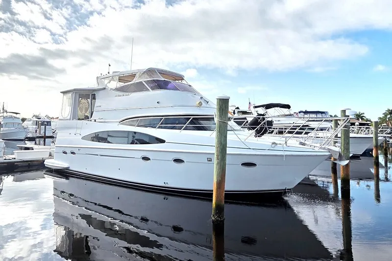 Slide: The Image of 2001 Carver 466 Motor Yacht docked at marina under cloudy sky. - 85