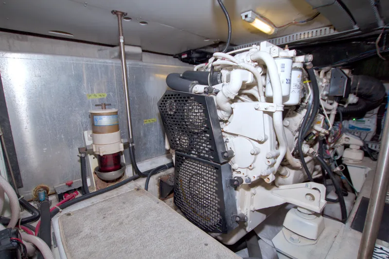 Slide: The Image of Engine room of a 2001 Carver 466 Motor Yacht, showcasing mechanical components and wiring. - 69