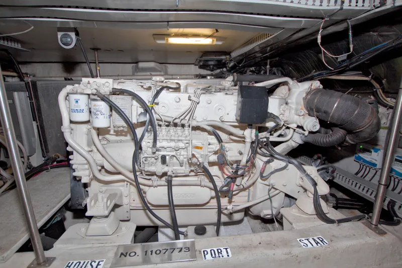 Slide: The Image of Engine room of a 2001 Carver 466 Motor Yacht, showcasing detailed machinery and wiring. - 71