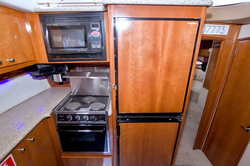 Slide: The Image of Kitchen area of 2001 Carver 466 Motor Yacht with stove, microwave, and fridge. - 39