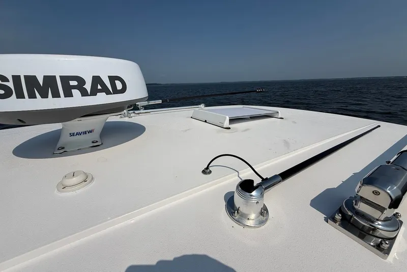 Slide: The Image of 2023 Reef Runner 34CC boat deck with Simrad radar and ocean view. - 30