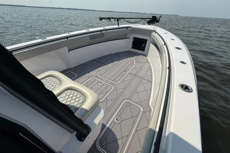 Slide: The Image of 2023 Reef Runner 34CC boat with spacious deck and seating on open water. - 22