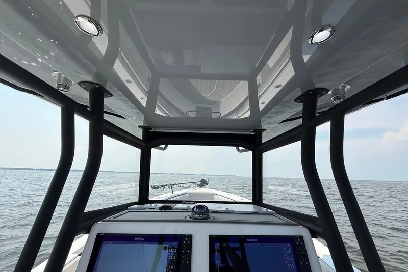 Slide: The Image of 2023 Reef Runner 34CC boat interior with navigation screens, open sea view. - 18