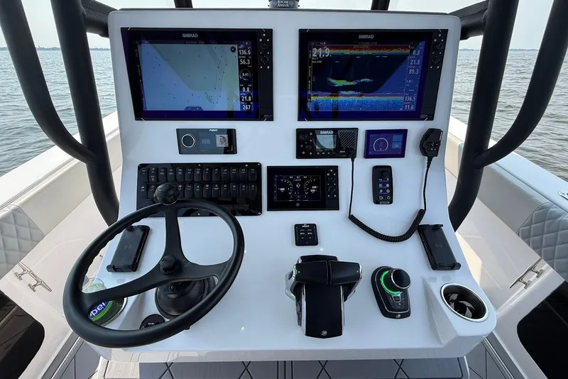Slide: The Image of 2023 Reef Runner 34CC boat dashboard with advanced navigation and control systems. - 16