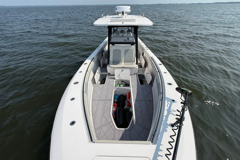 Slide: The Image of 2023 Reef Runner 34CC boat on open water, showcasing spacious deck and modern design. - 28