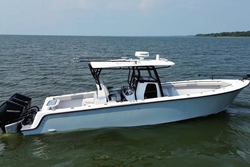 The Image of 2023 Reef Runner 34CC boat on open water, featuring sleek design and Mercury engines. - 1