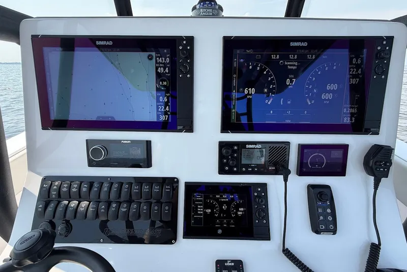 Slide: The Image of 2023 Reef Runner 34CC boat dashboard with advanced navigation and control systems. - 17