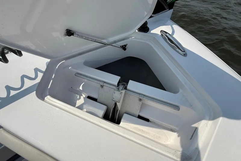 Slide: The Image of Open anchor compartment on 2023 Reef Runner 34CC boat, showing storage details. - 25